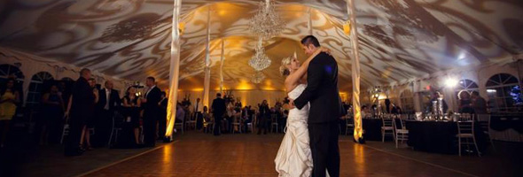 Event Lighting for the Perfect Setting! wedding couple dancing with event lighting gobos and amber uplighting in the background tent